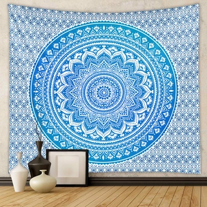 Blue and white mandala bohemian tapestry hanging on a minimalist living room wall