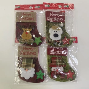 Detail of Christmas stocking set with reindeer and Santa 3D plush figures in packaging