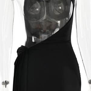 Detailed view of black asymmetric dress with ruched side and elegant drape detail