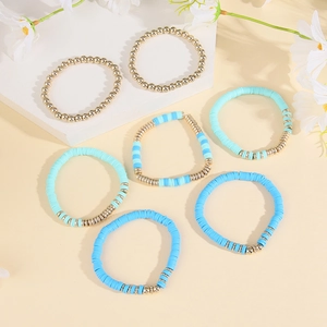 Detailed shot of 6-piece bohemian polymer clay and gold bead elastic bracelets
