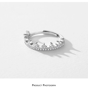 Macro shot of silver crown ring with pavé-set cubic zirconia and adjustable band