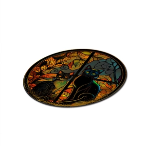 Close-up of circular acrylic Halloween coaster featuring colorful stained-glass style black cats
