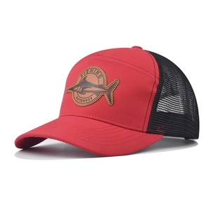 Close-up of fishing patch on red and black mesh trucker hat with reinforced brim