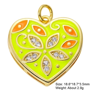Macro shot of gold-plated heart pendant with neon green and orange enamel and zircons