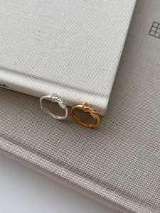 Detailed view of S925 silver bow rings with sparkling zircons and hallmark stamp
