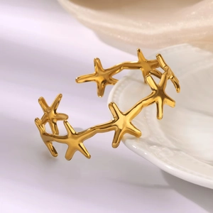 Macro shot of gold starfish cuff bracelet with polished ocean theme detail