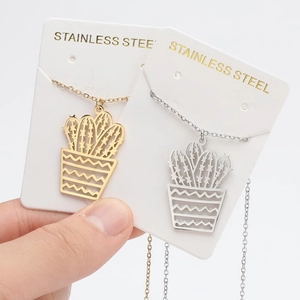 Minimalist cactus pendant necklaces in gold and silver stainless steel on display cards