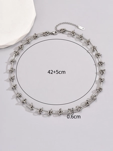 Detail of silver chain necklace with lobster clasp, K18 tag and size info 42+5cm