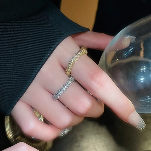 Macro detail of gold and silver plated twist rings with pavé cubic zirconia