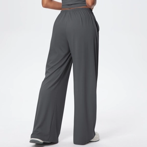 Detail view of high waist elastic band and side pocket on dark grey wide leg trousers