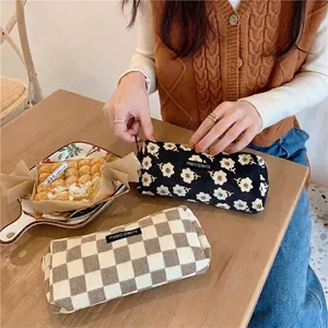 Vintage corduroy pencil case with black floral and checkerboard patterns for students