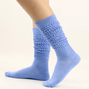 Detail of light blue slouch socks featuring a unique wavy textured knit pattern