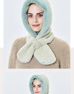 Detail of the thick plush lining and soft faux fur edges on the mint green winter hood