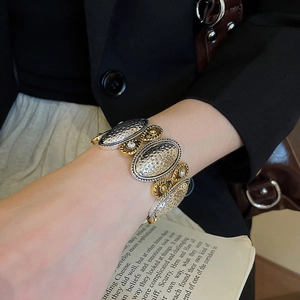 Detail of two-tone hammer textured metal bracelet with crystal inlay on a vintage model