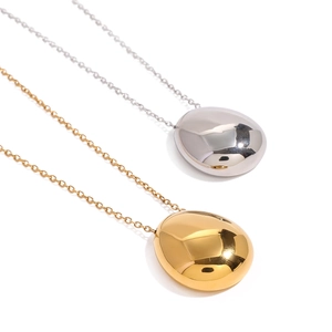 Polished gold and silver pebble pendant necklaces on a clean white background