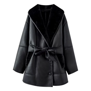 Women's black faux leather jacket with fur collar and waist belt in a minimalist style