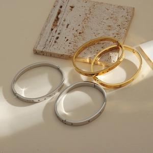 Artistic layout of gold and silver hinged metal bracelets with micro-inlaid diamond details