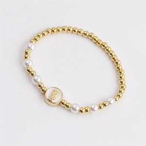 Bohemian style beaded bracelet with gold beads, white pearls and Virgin Mary medal