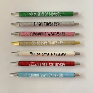 Detailed set of 7 glitter Christmas ballpoint pens with weekday holiday phrases