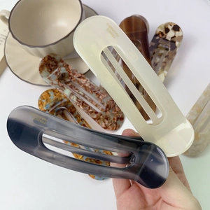 Handmade acetate hair clips in tortoiseshell and cream finishes with hollowed rectangular design