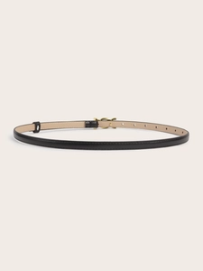 Detail of slim black leather belt with gold metal buckle and light beige inner lining