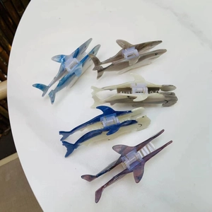 Shark-shaped acetate hair claws in blue, grey, and purple marble patterns for women
