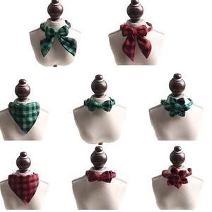 Detail of red and green buffalo plaid cat collars with bowties and floral accessories