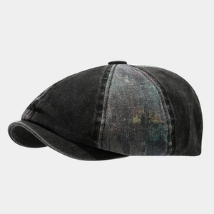 Close-up of vintage newsboy cap showing washed denim texture and colorful tie-dye print