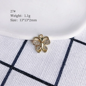 Detailed view of a gold plated butterfly pendant with crystals, size 13x13mm, 1.1g weight