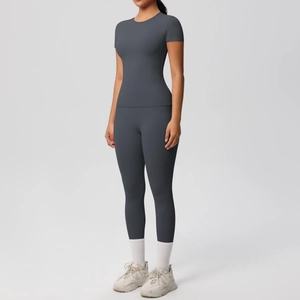 Detail of high-waist yoga set with slim-fit short sleeve top and leggings in dark grey