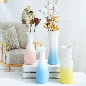 Detailed view of modern pastel ceramic vases in pink, blue and yellow gradient colors