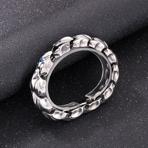 Close-up of silver punk keel chain bracelet for men on textured black surface