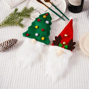 Detailed view of Christmas gnome wine bottle covers with festive tree and reindeer designs