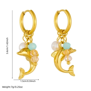 Golden dolphin charm earrings with pearls and colorful faceted beads on white background