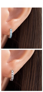 Detailed tile display of two hoop earrings with blue and white inlaid opal stones