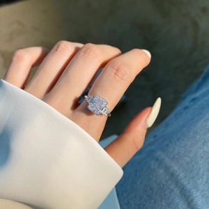 Macro shot of a sparkling radiant-cut zircon ring with side stones on a silver band