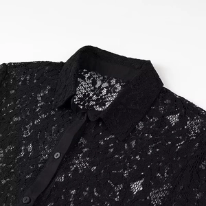 Close-up of intricate black lace texture on collar and buttoned placket of a polo shirt