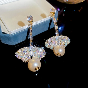 Detailed close-up of golden tassel earrings with colorful zircons and round pearls