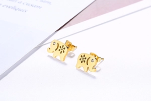 Macro shot of gold elephant earrings featuring hollow patterns and white cubic zirconia