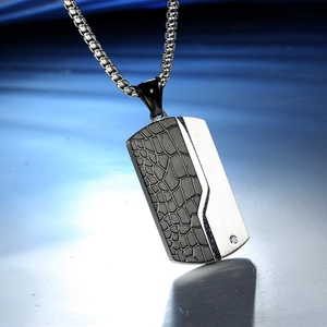 Men's dog tag necklace featuring crocodile texture and brushed metal with a small diamond
