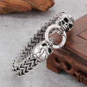 Close-up of a silver skull clasp on a thick punk chain made of stainless steel