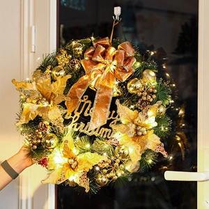 Luminous Christmas wreath with golden ornaments, pine needles and LED lights decoration