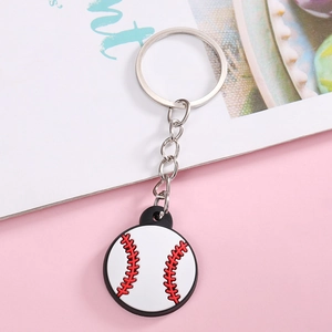 Macro shot of white baseball keychain with red stitching and silver metal chain