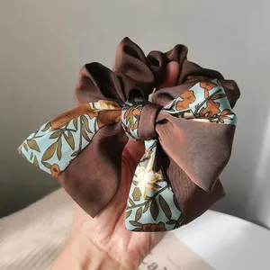 Vintage oversized bow scrunchie featuring brown rib fabric and light blue floral print