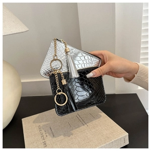 Detail of silver and black crocodile pattern mini purses with tassel keychain charms