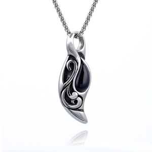 Vintage tiger eye pendant necklace with ornate silver pattern and black stone drop