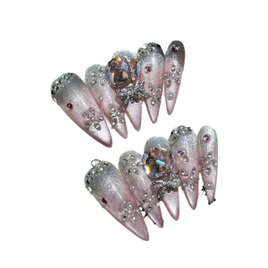 Pink gradient handmade press-on nails with luxury rhinestones and metal bow charms