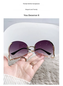 Detailed view of frameless round ocean lenses with gold metal bridge and purple gradient