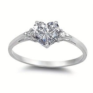 Macro shot of silver heart ring with large heart-cut stone and side diamonds