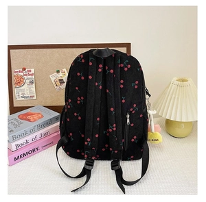 Detail of corduroy backpack back with cherry pattern, padded straps and anti-theft pocket
